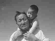 Grandfather and grandson of Japanese ancestry at Manzanar Relocation Center, Manzanar, California.