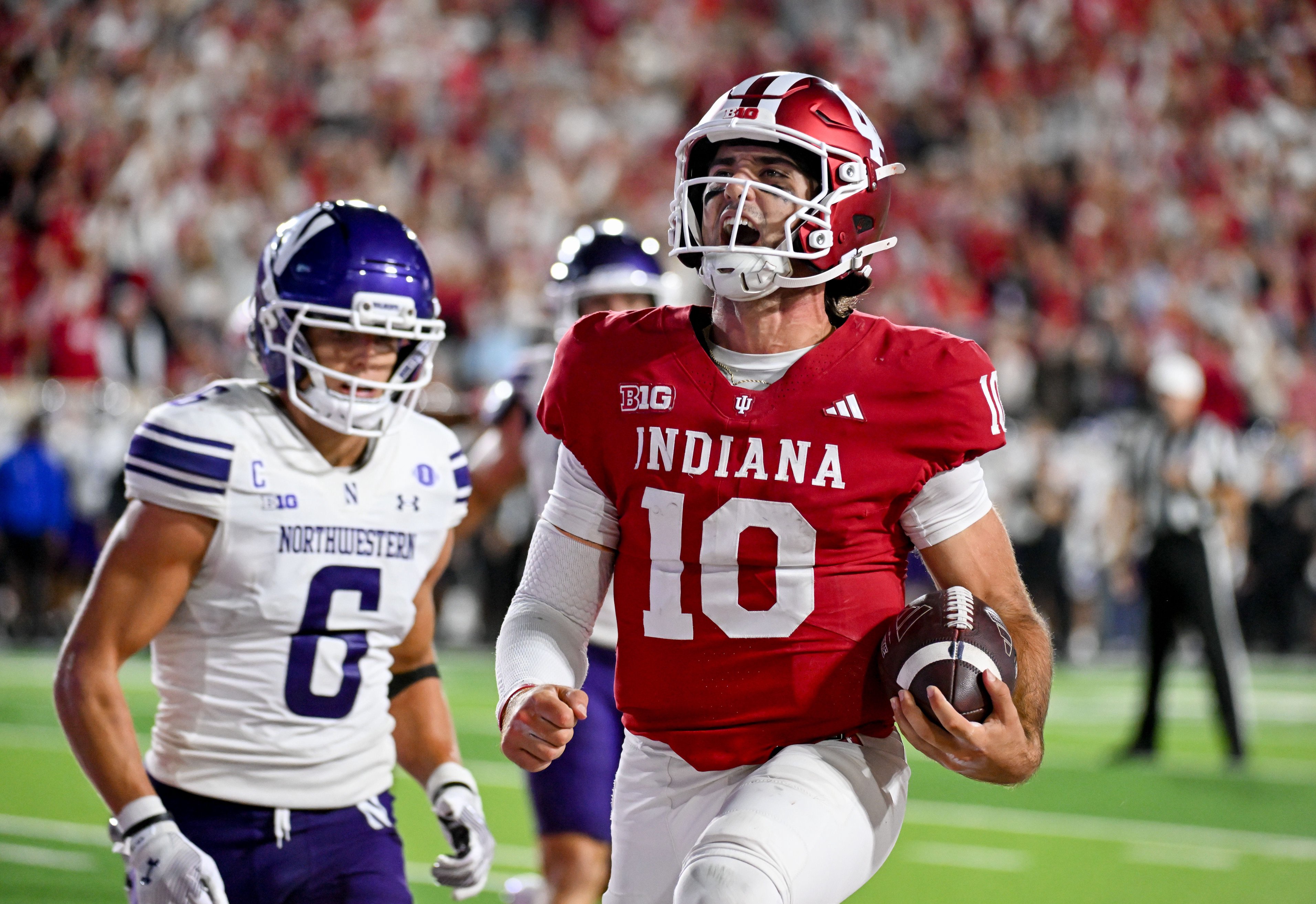 Sep 25, 2026; Bloomington, Indiana, USA; Indiana Hoosiers quarterback Josh Hoover (10) celebrates after running for a touchdown against the Northwestern Wildcats during the second half at Merchants Bank Field at Memorial Stadium. Mandatory Credit: Robert Goddin-Imagn Images