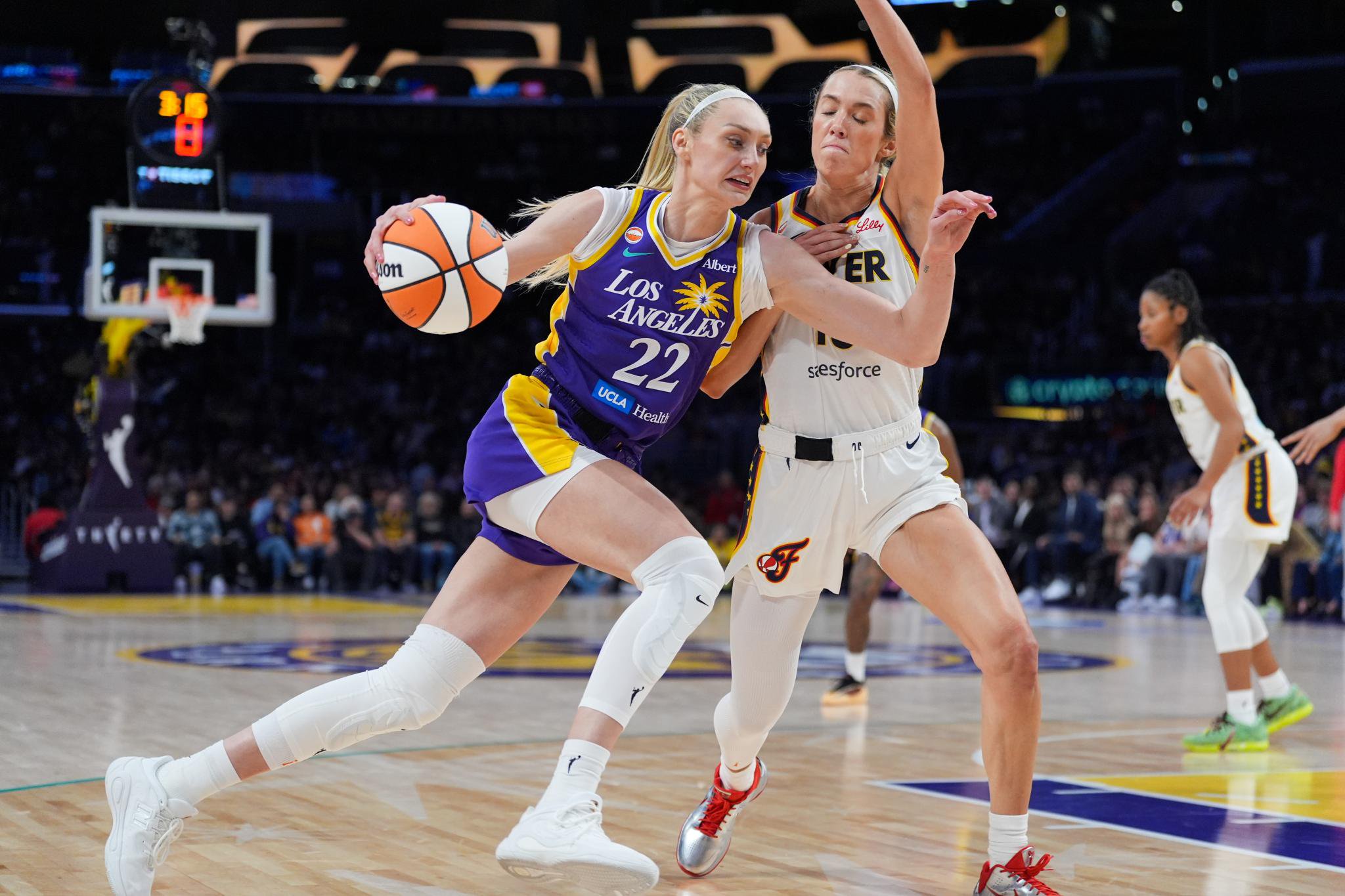 Los Angeles Sparks forward Cameron Brink (22) is pressured by Indiana Fever guard Lexie Hull (10) during the second half of a WNBA basketball game Wednesday, May 13, 2026, in Los Angeles.