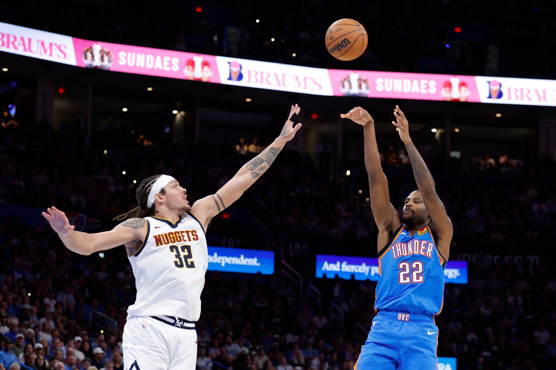 Mar 9, 2026; Oklahoma City, Oklahoma, USA; Oklahoma City Thunder guard Cason Wallace (22) shoots a three point basket as Denver Nuggets forward Aaron Gordon (32) defends during the second half at Paycom Center. Mandatory Credit: Alonzo Adams-Imagn Images