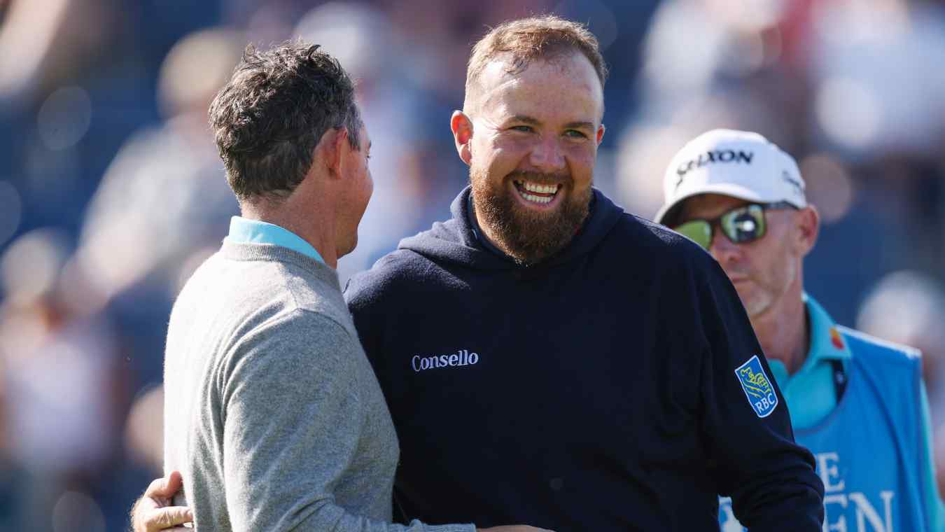 Rory McIlroy and Shane Lowry embrace during a practice round at the 2026 Open Championship