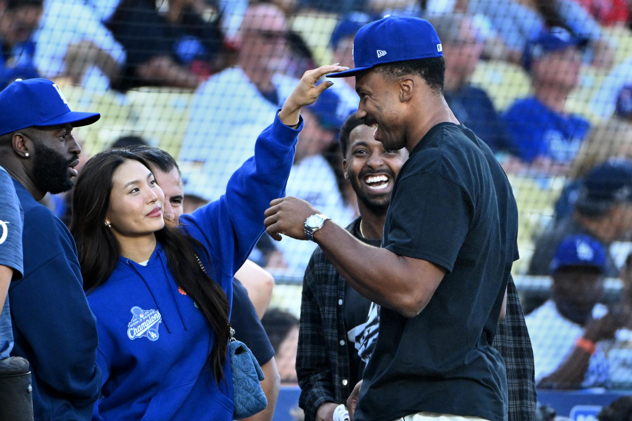 Los Angeles Rams player Myles Garrett and his partner, Olympian Chloe Kim, have fun before a game between the Los Angeles Dodgers and the Los Angeles Angels in Los Angeles, Saturday, June 6, 2026.