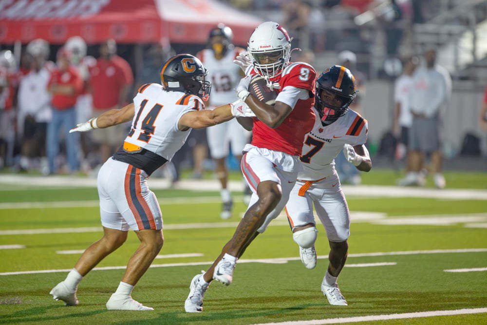 Ruston's Ahmad Hudson runs through two Catholic-Baton Rouge defenders on his way to a touchdown Friday, Sept. 25, 2026. 