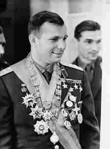 Yuri Gagarin in military uniform decorated with many medals. 