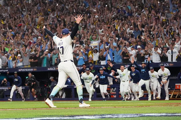 Tampa Bay Rays pitcher Bryan Baker celebrates their win against the Cleveland Guardians in Game 6 of an American League Championship Series baseball game in St. Petersburg, Fla. Monday, Oct. 19, 2026. (AP Photo/David J. Phillip)