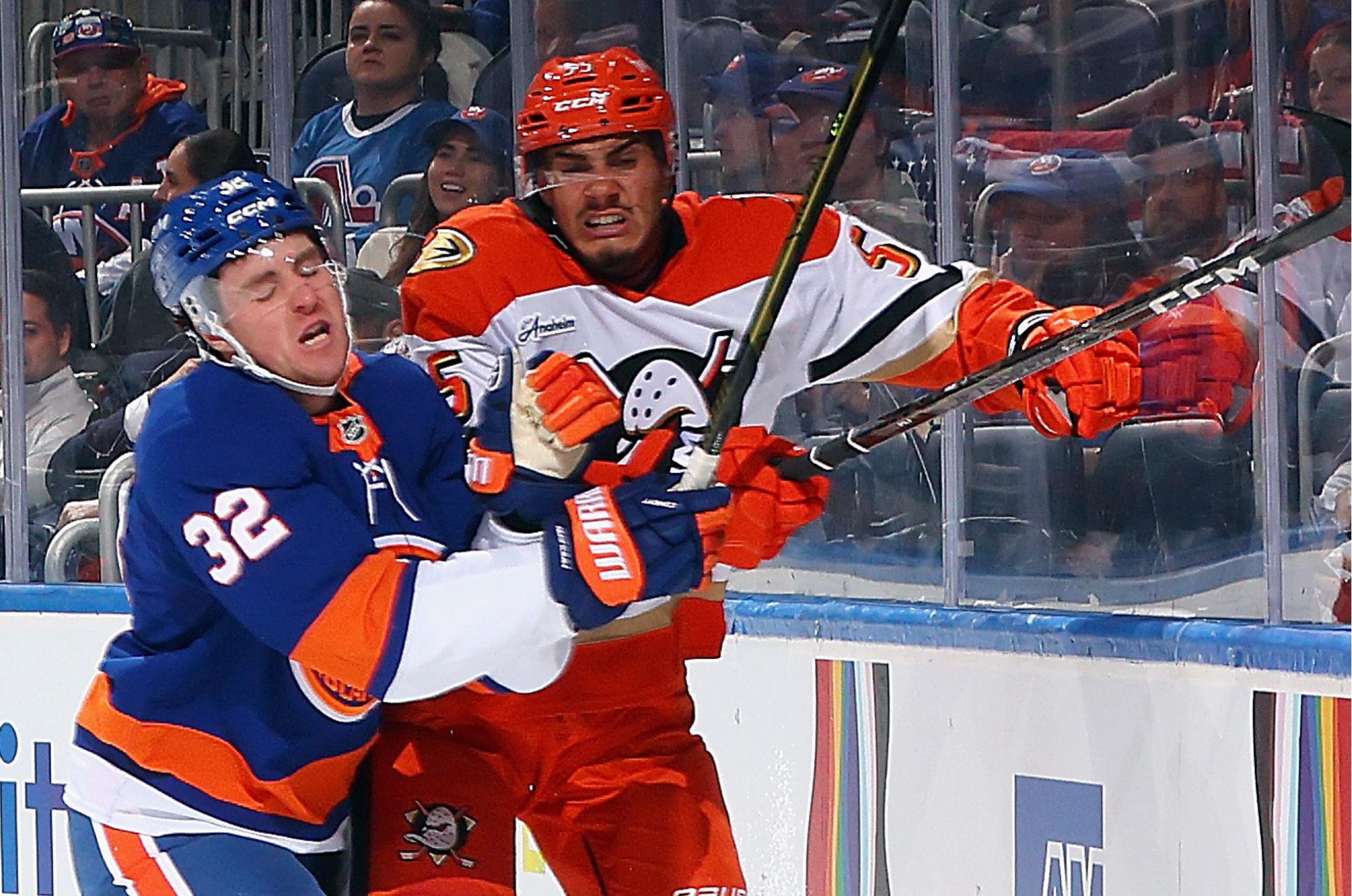 Kyle MacLean checks Tyson Hinds into the boards during the Islanders' 3-2 win over the Ducks on Oct. 20, 2026 at UBS Arena.