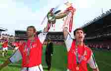 Arsenal defensive icons Tony Adams and Keown hold the Prem trophy in 2002