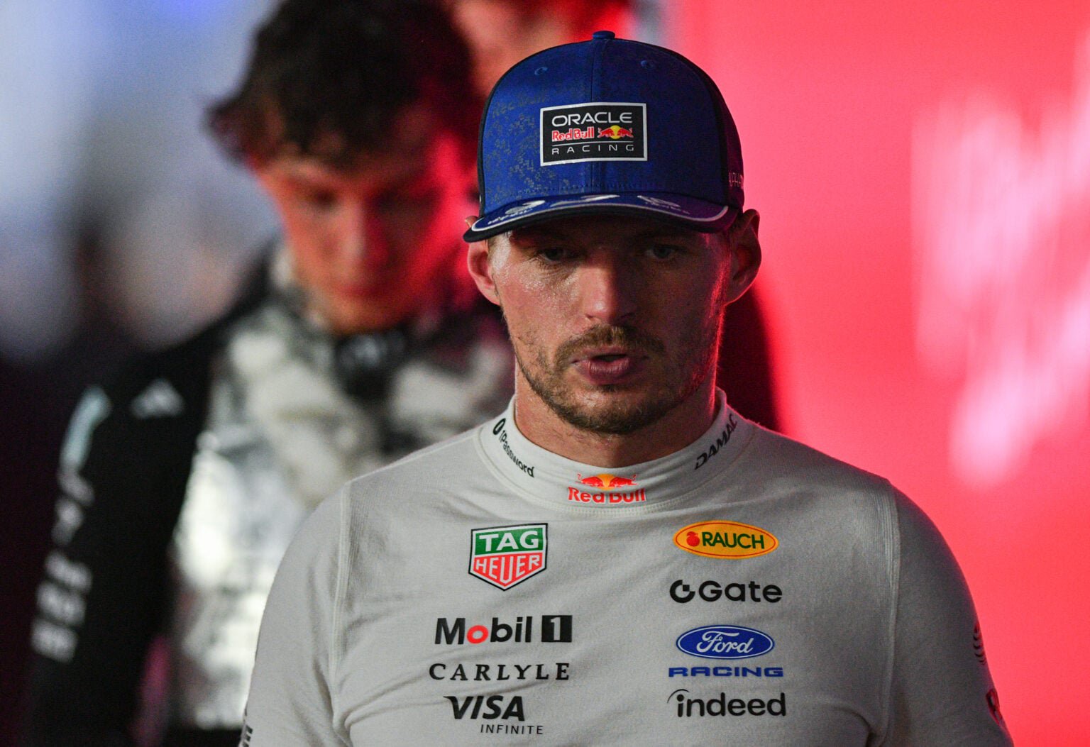 Max Verstappen walking ahead of Kimi Antonelli in Singapore.