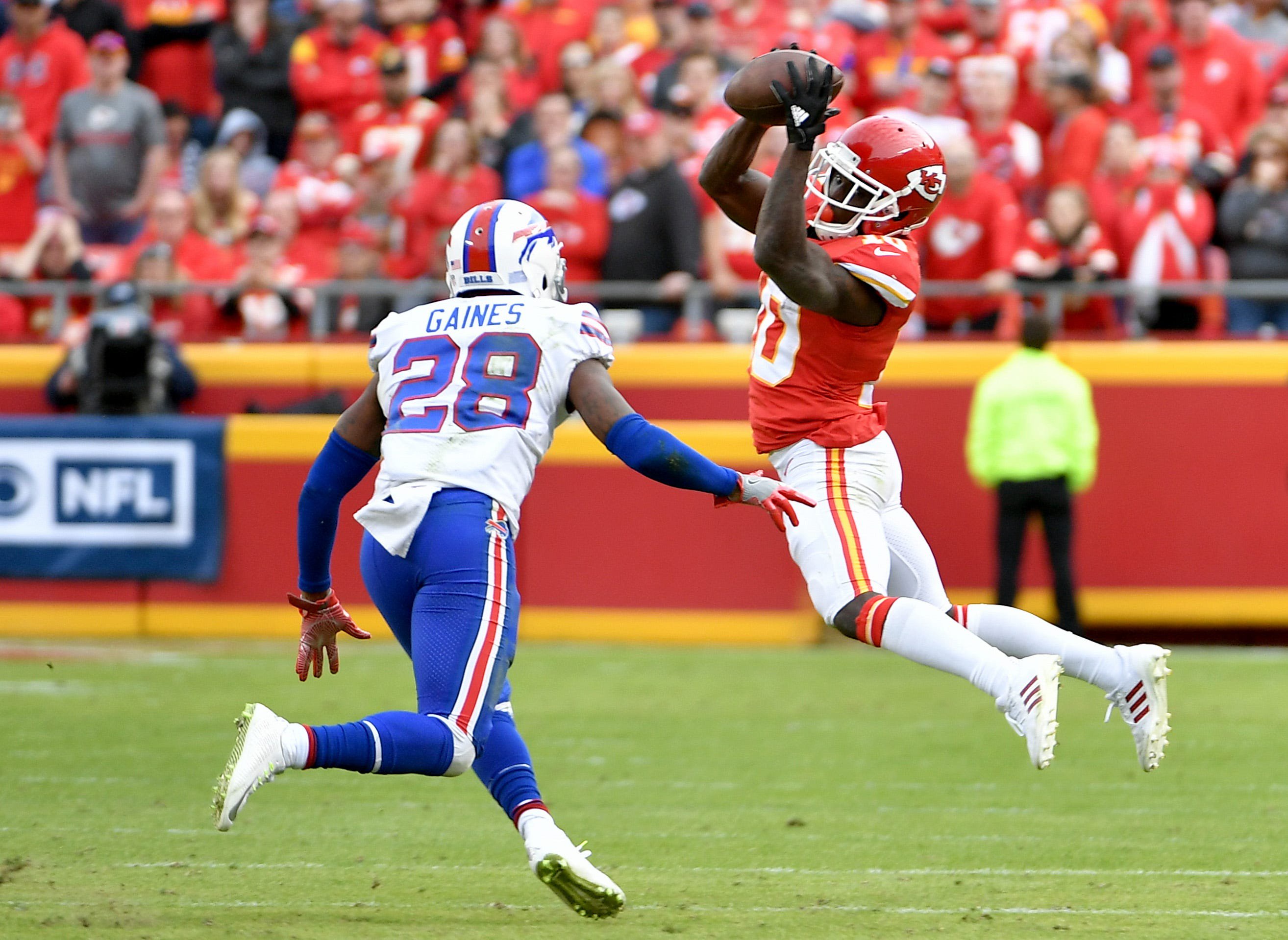 Nov 26, 2017; Kansas City, MO, USA; Kansas City Chiefs wide receiver Tyreek Hill (10) catches a pass as Buffalo Bills cornerback E.J. Gaines (28) defends during the game at Arrowhead Stadium. Mandatory Credit: Denny Medley-USA TODAY Sports