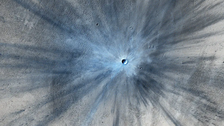 NASA's Mars Reconnaissance Orbiter captured an image of a fresh impact crater on Mars in 2013.