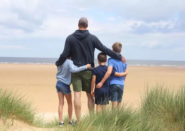 Prince George, Princess Charlotte and Prince Louis stand with Prince William on a beach in 2024 Father's Day photo, taken by Kate Middleton