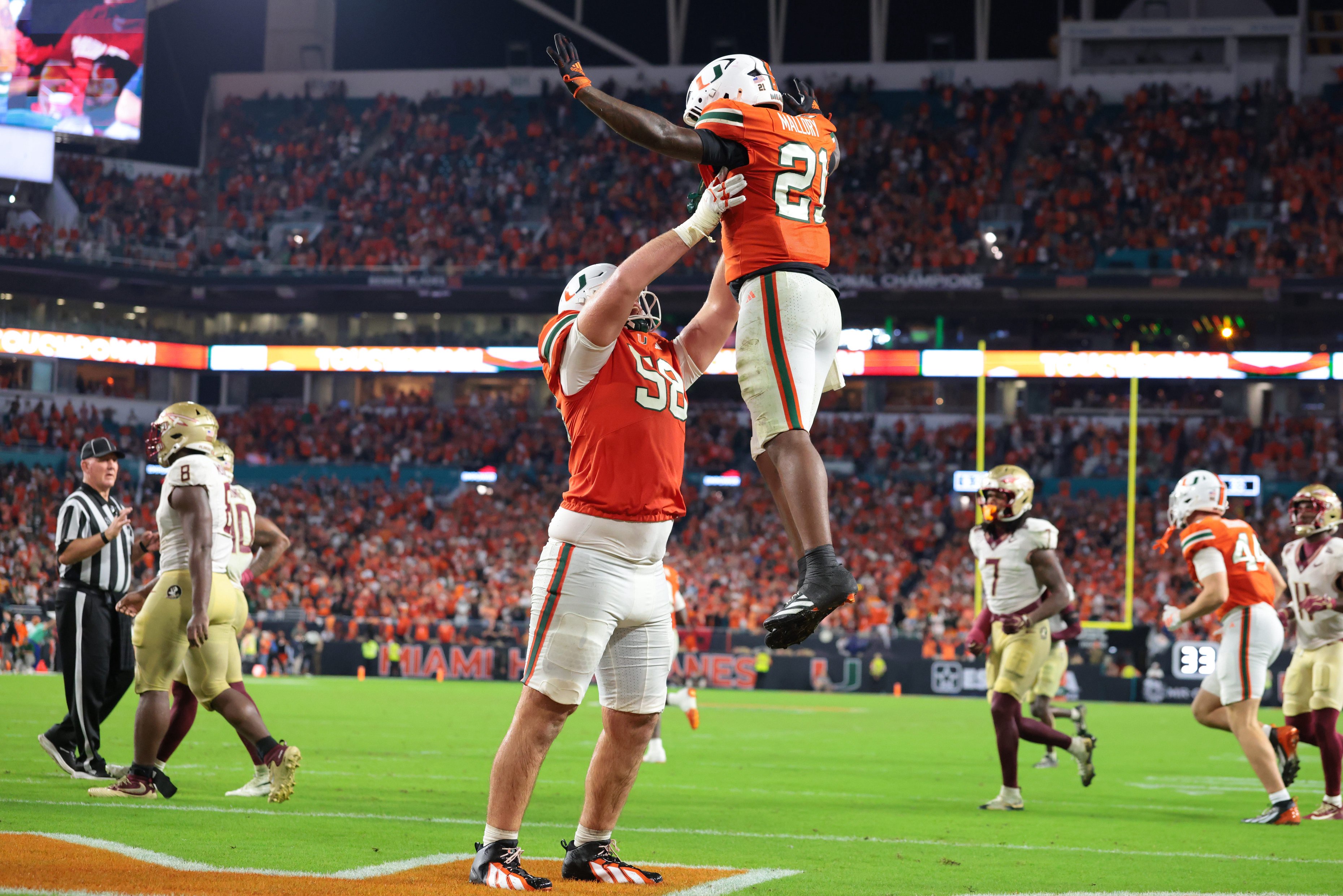 Oct 17, 2026; Miami Gardens, Florida, USA;  Miami Hurricanes running back Javian Mallory (21) celebrates with offensive lineman Ben Congdon (58) after a touchdown during overtime against the Florida State Seminoles at Hard Rock Stadium.  Mandatory Credit: Sam Navarro-Imagn Images
