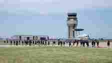Premier College Intern Program members walk on the flightline across from an E-3 Sentry aircraft June 26, 2024, at Tinker Air Force Base, Oklahoma.