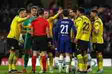 Dortmund stars surround the referee after he let Chelsea re-take the penalty