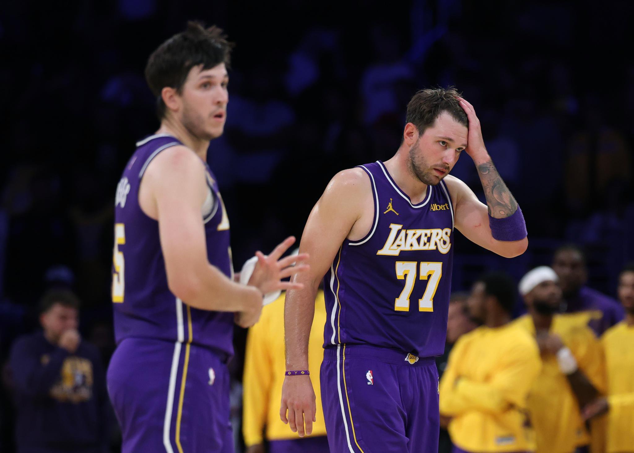 Luka Doncic and Austin Reaves of the Los Angeles Lakers react during a game.