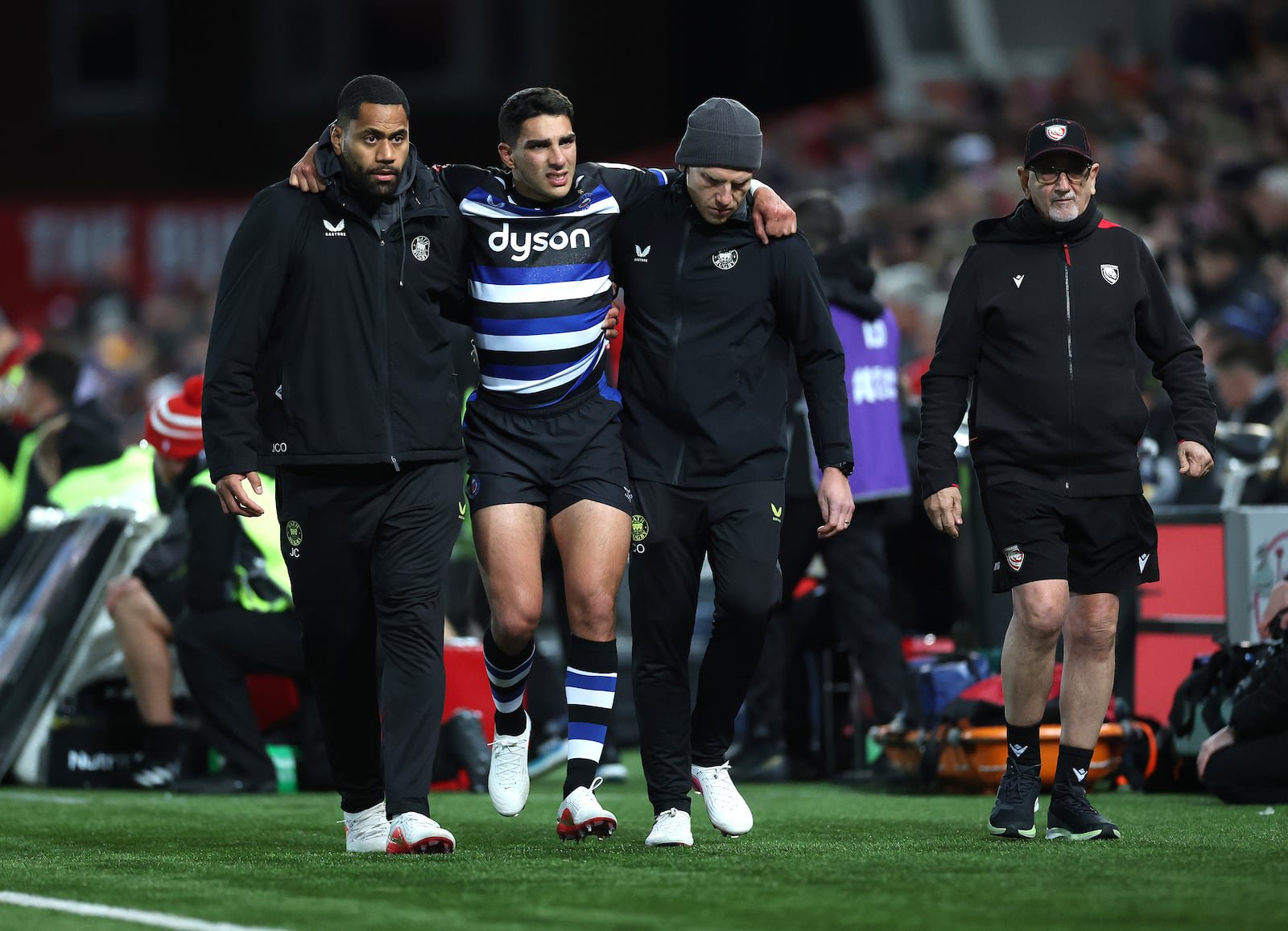 Santiago Carreras of Bath is helped off the pitch after injuring his right leg. Photograph: David Rogers/Getty