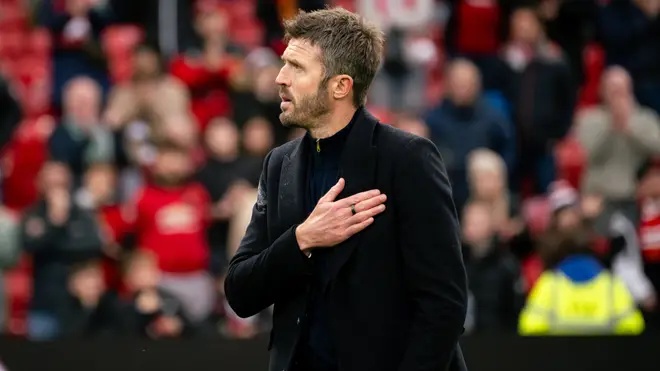Carrick reacts to the fans' support at full-time.