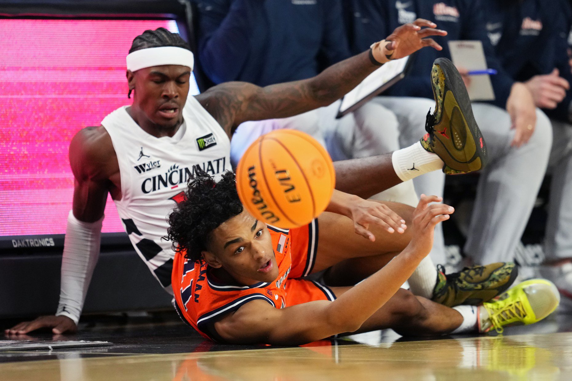Tylen Riley of Cincinnati and Quentin Coleman of Illinois dive after a loose ball in the first half of an exhibition game Oct. 17, 2026, in Cincinnati. (Dylan Buell/Getty Images)