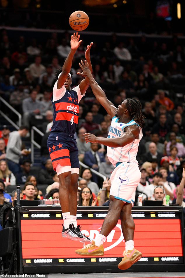 Washington Wizards forward AJ Dybantsa (4) shoots against Charlotte Hornets guard Sion James, right, during the first half of an NBA Cup basketball game, Friday, Oct. 30, 2026, in Washington. (AP Photo/Nick Wass)
