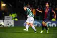 Celtic player Tony Watt (l) scores the second goal watched by Barcelona player Javier Mascherano during the UEFA Champions League Group G match bet...