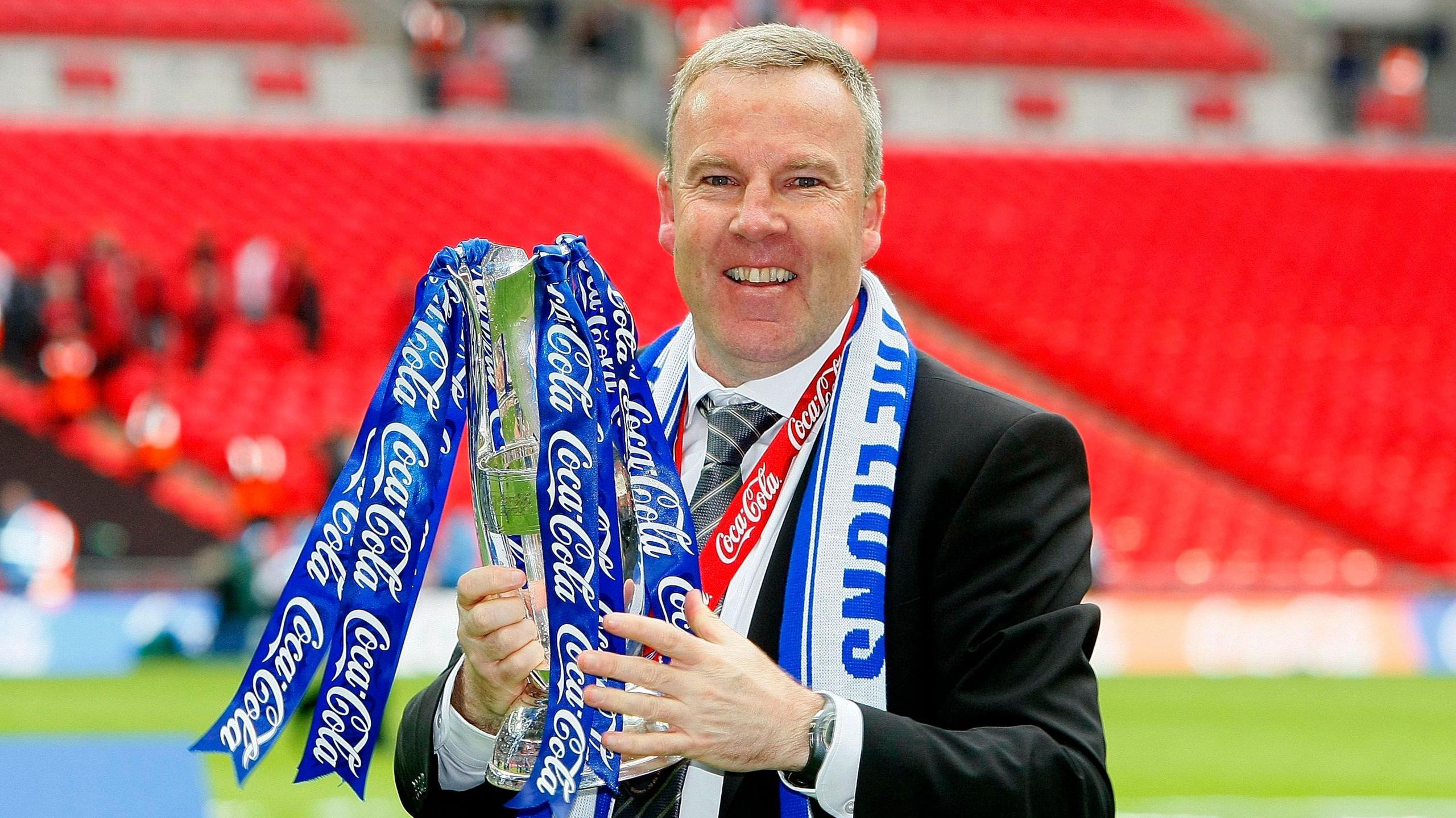 Manager of Millwall Kenny Jackett celebrates with the trophy after his team won the Coca Cola League One Playoff Final between Millwall and Swindon Town at Wembley Stadium