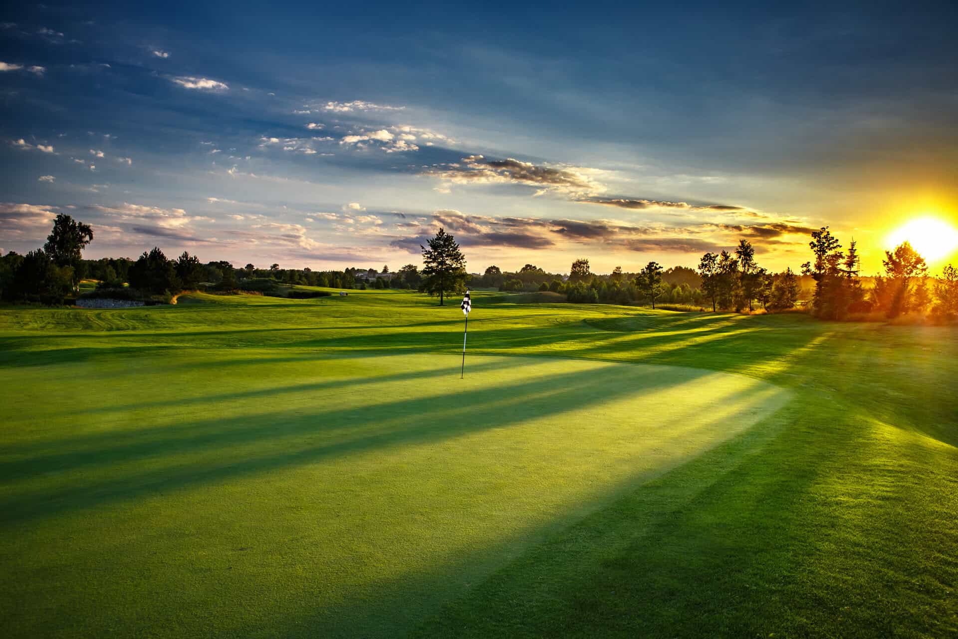 Sunset at the golf course | Source: Adobe