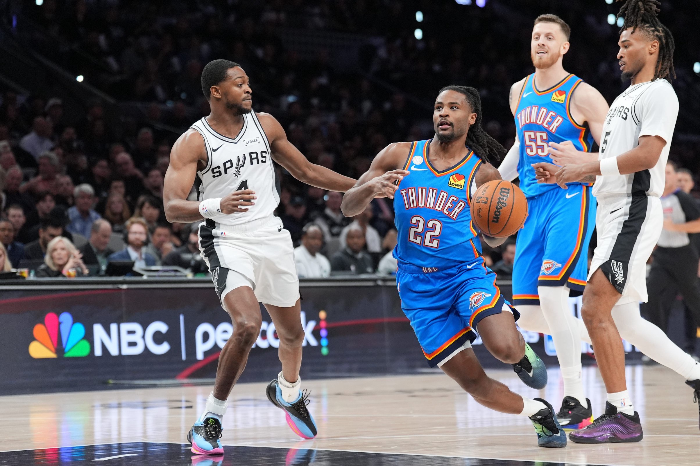 Oct 20, 2026; San Antonio, Texas, USA;  Oklahoma City Thunder guard Cason Wallace (22) controls the ball against San Antonio Spurs guard De'aaron Fox (4) in the second half at Frost Bank Center.  Mandatory Credit: Daniel Dunn-Imagn Images