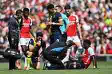 Bukayo Saka receives medical treatment after a tackle during Arsenal vs AFC Bournemouth