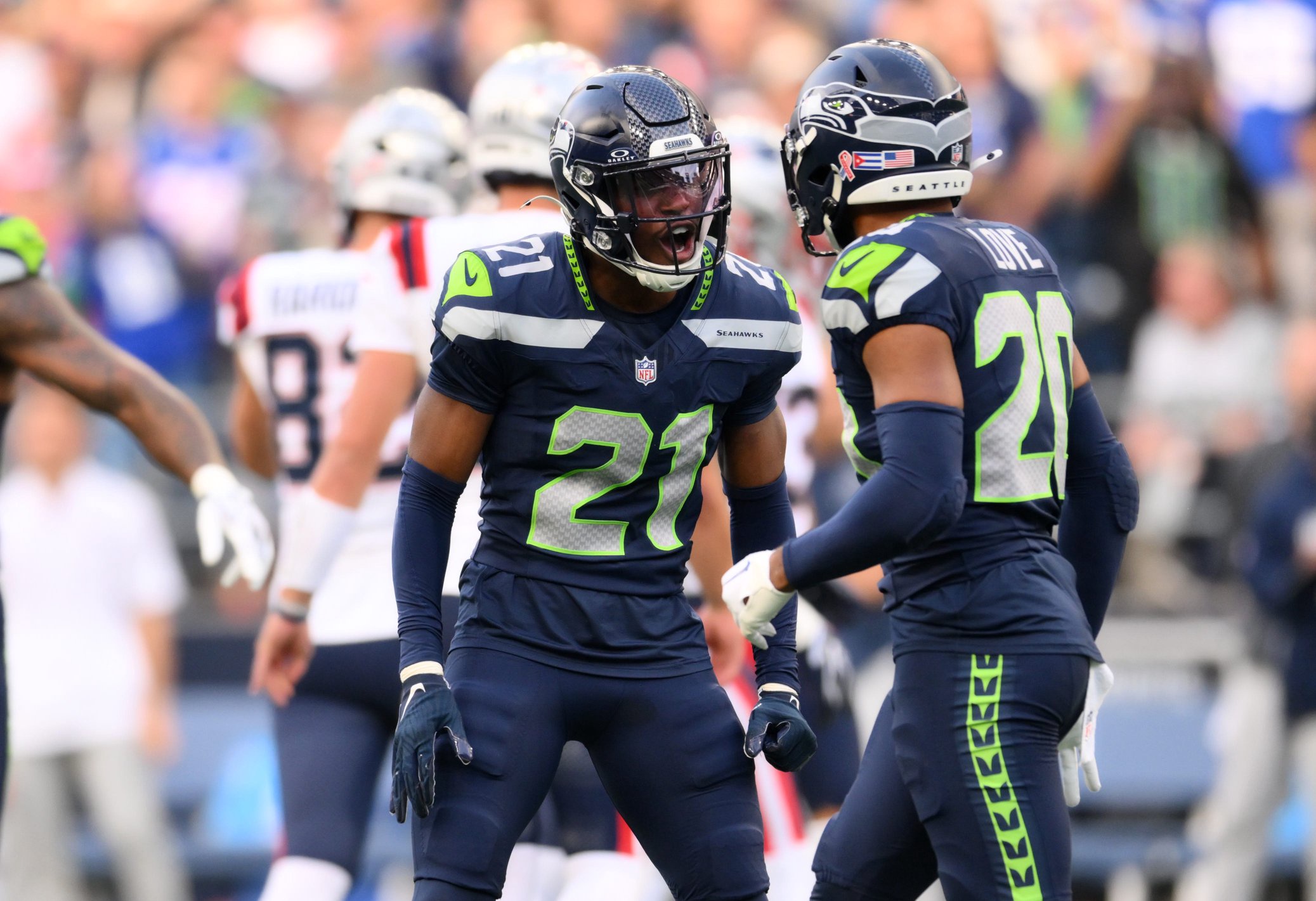 Sep 9, 2026; Seattle, Washington, USA;  Seattle Seahawks cornerback Devon Witherspoon (21) celebrates with safety Julian Love (20) after a stop during the first quarter against the New England Patriots at Lumen Field.  Mandatory Credit: Steven Bisig-Imagn Images
