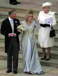 Her Majesty Queen Elizabeth wore a white coat dress to the wedding of Prince Charles and his wife Camilla, Duchess of Cornwall in 2005
