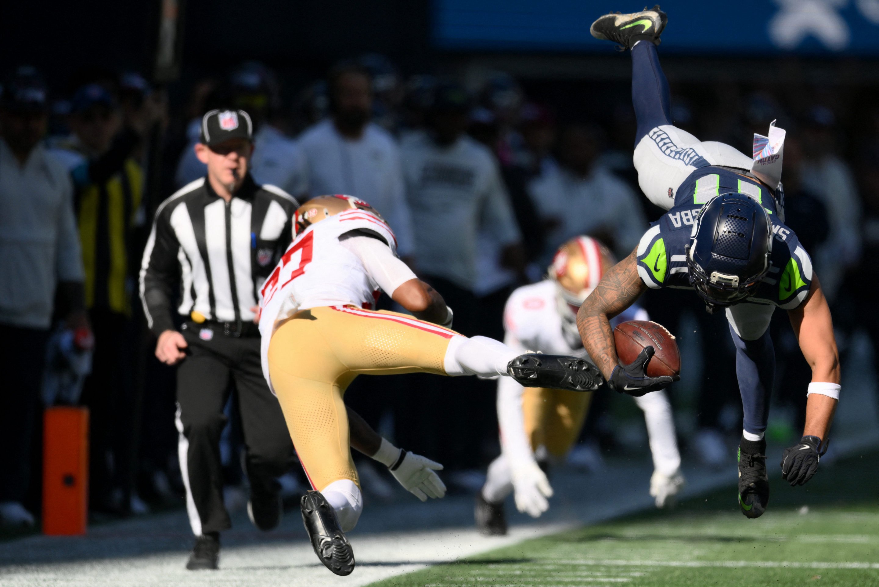 San Francisco 49ers safety Ji'Ayir Brown (27) tackles Seattle Seahawks wide receiver Jaxon Smith-Njigba (11) during the first half at Lumen Field. 