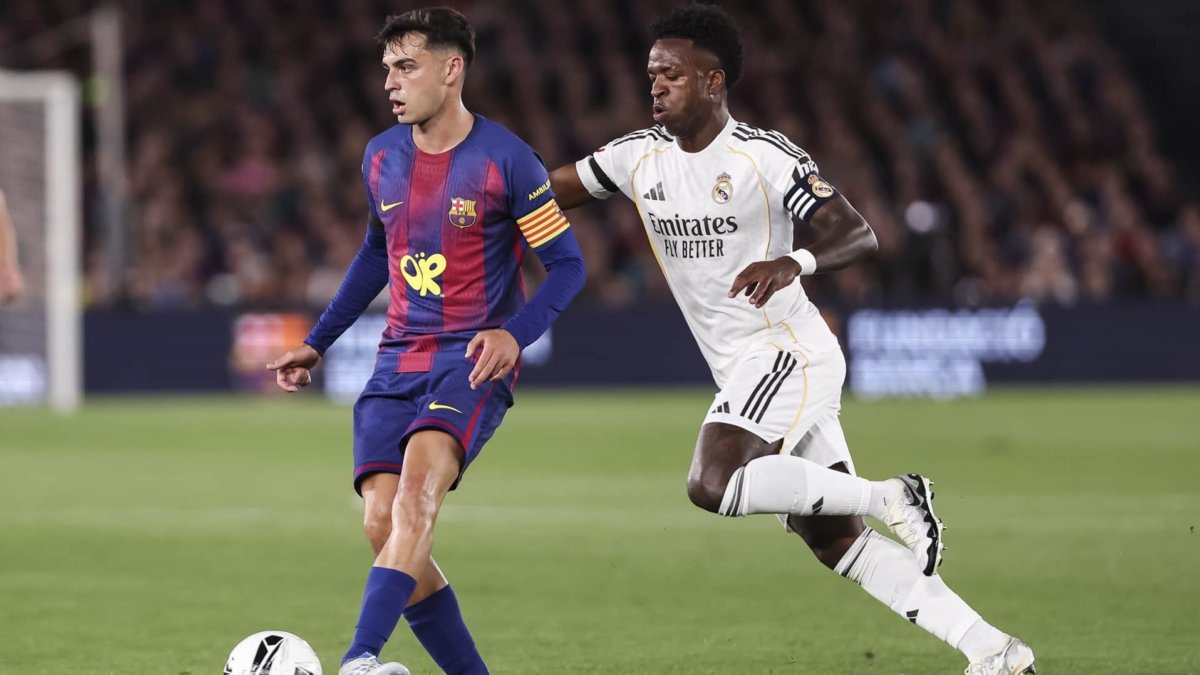 Europapress pedri of fc barcelona and vinicius junior of real madrid cf in action