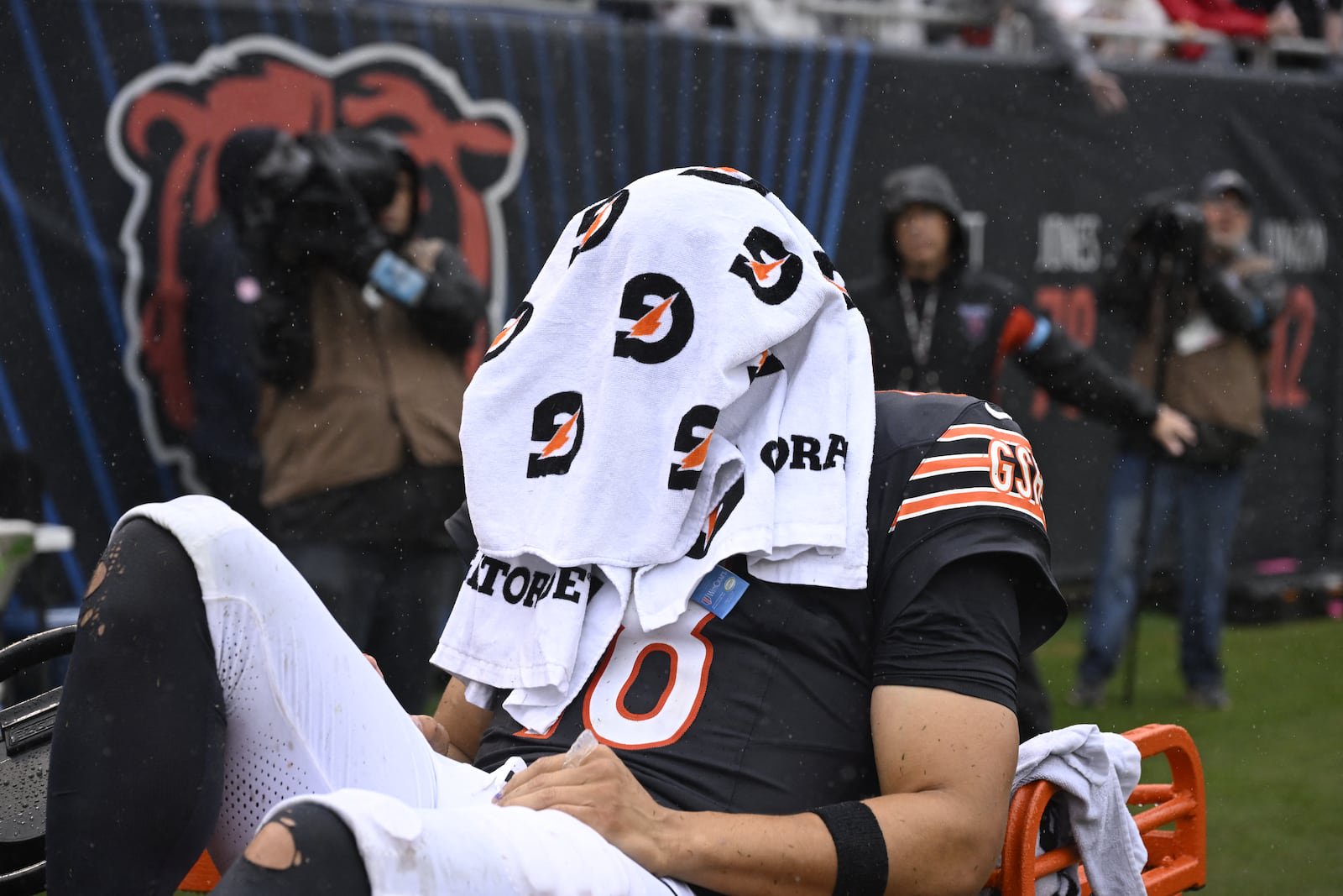 Sep 20, 2026; Chicago, Illinois, USA;  Chicago Bears quarterback Caleb Williams (18) sits with a towel over his head as he is carted-off the field with an apparent injury against the Minnesota Vikings during the second half at Soldier Field.  Mandatory Credit: Matt Marton-Imagn Images
