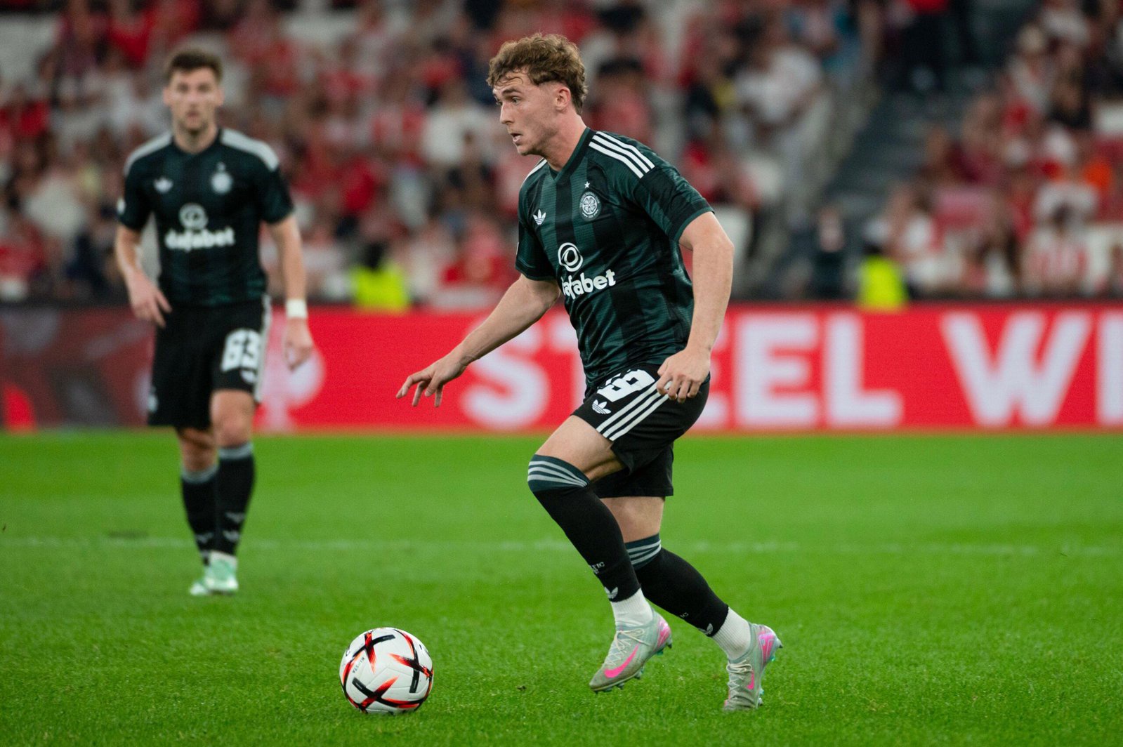 Celtic forward Callum Osmand runs with the ball against Benfica in the Europa League at the Estadio da Luz