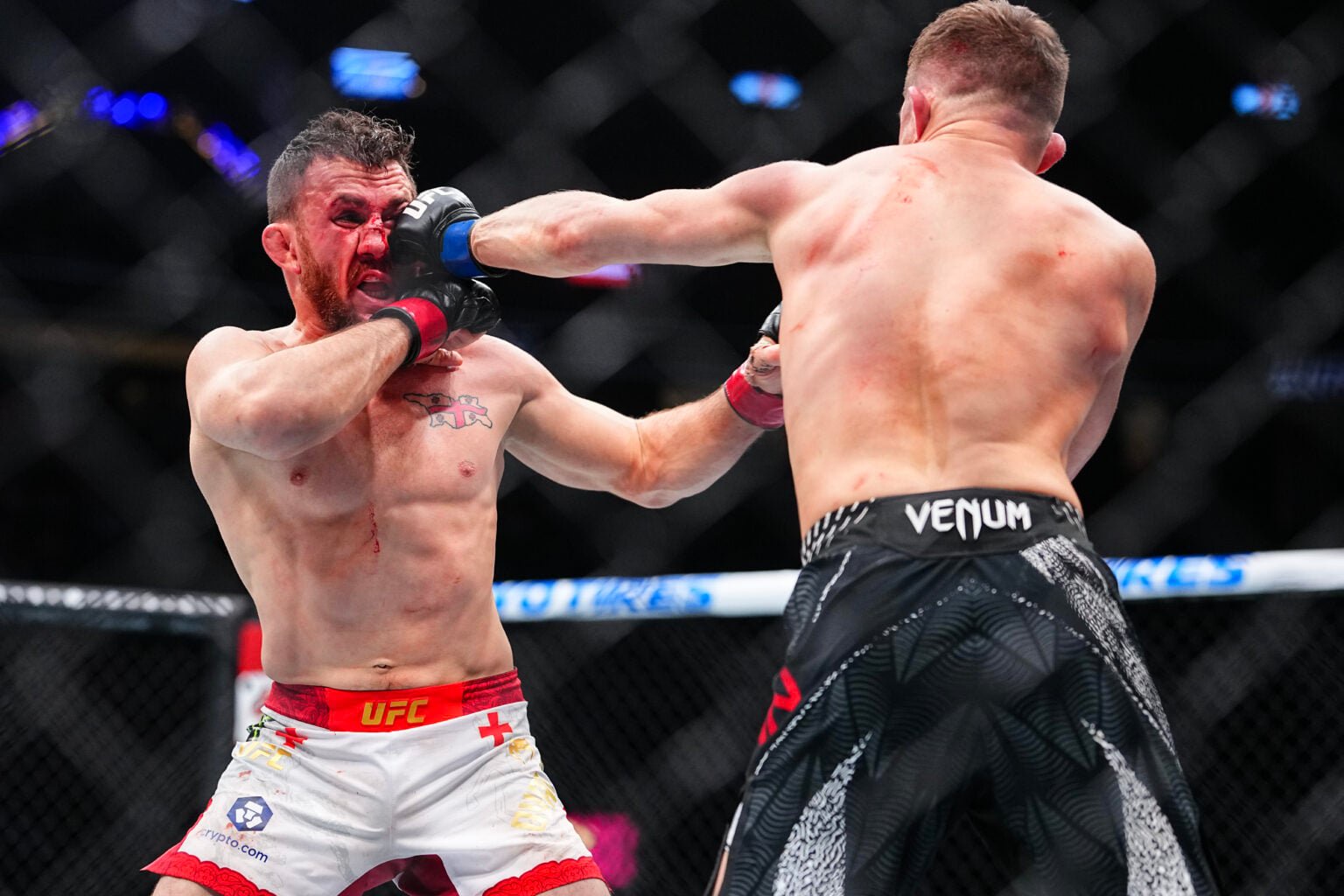 Petr Yan (back shown only) punches Merab Dvalishvili in their second UFC fight