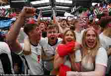 England fans celebrate after Jude Bellingham scores their first goal as they watch the match at BoxPark Wembley