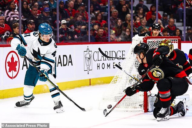 Ottawa Senators' Carter Yakemchuk, front right, attempts to block a shot by San Jose Sharks' Ivar Stenberg (41) during the first period of an NHL hockey game in Ottawa, Ontario, Thursday, Oct. 22, 2026. (Keito Newman/The Canadian Press via AP)