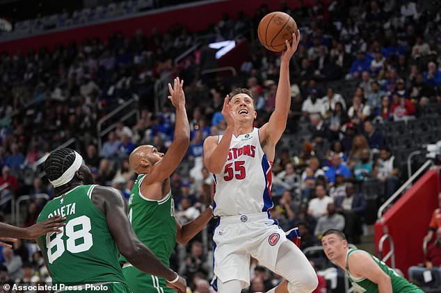 Detroit Pistons forward Duncan Robinson (55) shoots on Boston Celtics guard Derrick White (9) in the second half of an NBA basketball game in Detroit, Tuesday, Oct. 20, 2026. (AP Photo/Paul Sancya)