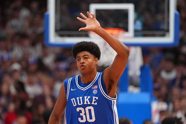 Duke's Joaquim Boumtje Boumtje celebrates after making a basket during the first half of an exhibition NCAA college basketball game against Kansas, Sunday, Oct. 25, 2026, in Lawrence, Kan. (AP Photo/Charlie Riedel)