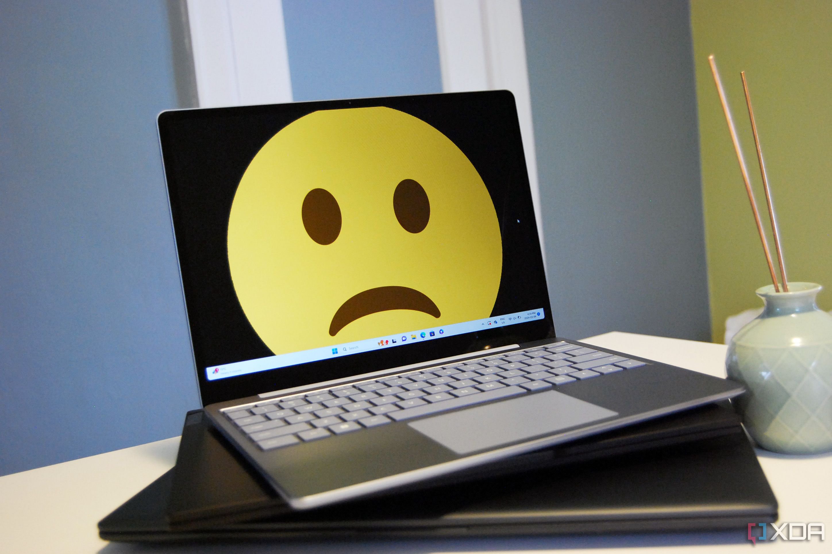 A Surface Laptop Go with a sad face
