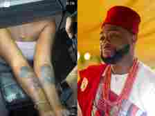 Davido reacts as a female fan tattoos his face and that of his wife, Chioma on her hand
