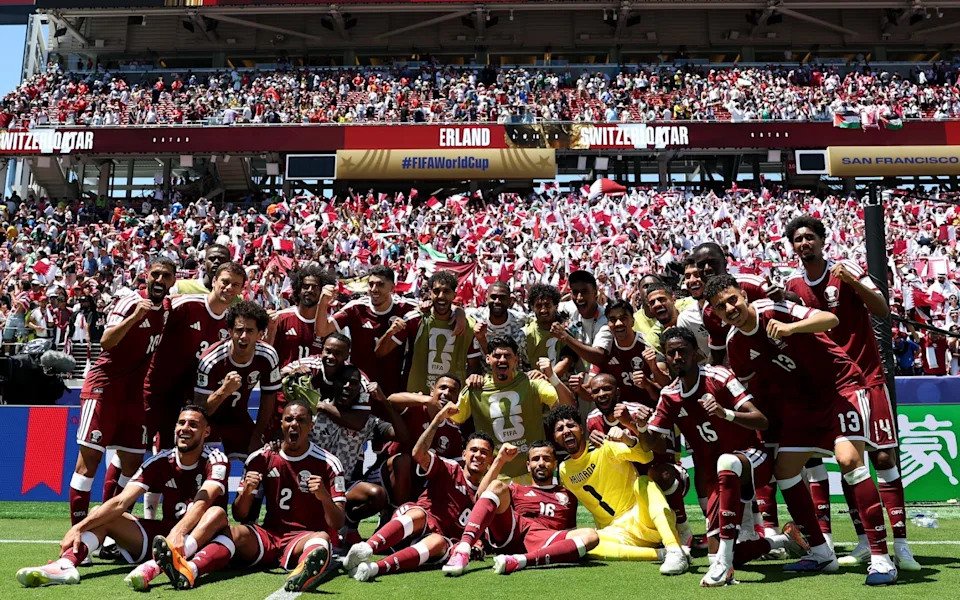 Qatar players pose for a picture after drawing with Switzerland