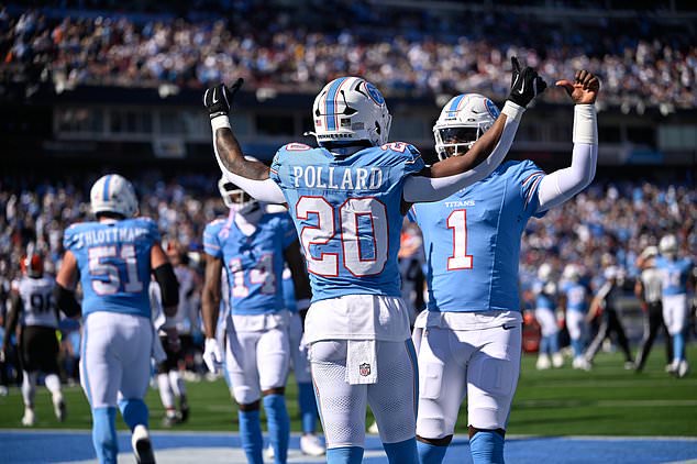 Tennessee Titans running back Tony Pollard (20) celebrates with quarterback Cam Ward (1) afer scoring a touchdown during the first half of an NFL football game against the Cleveland Browns in Nashville, Tenn., Sunday, Oct. 25, 2026. (AP Photo/John Amis)