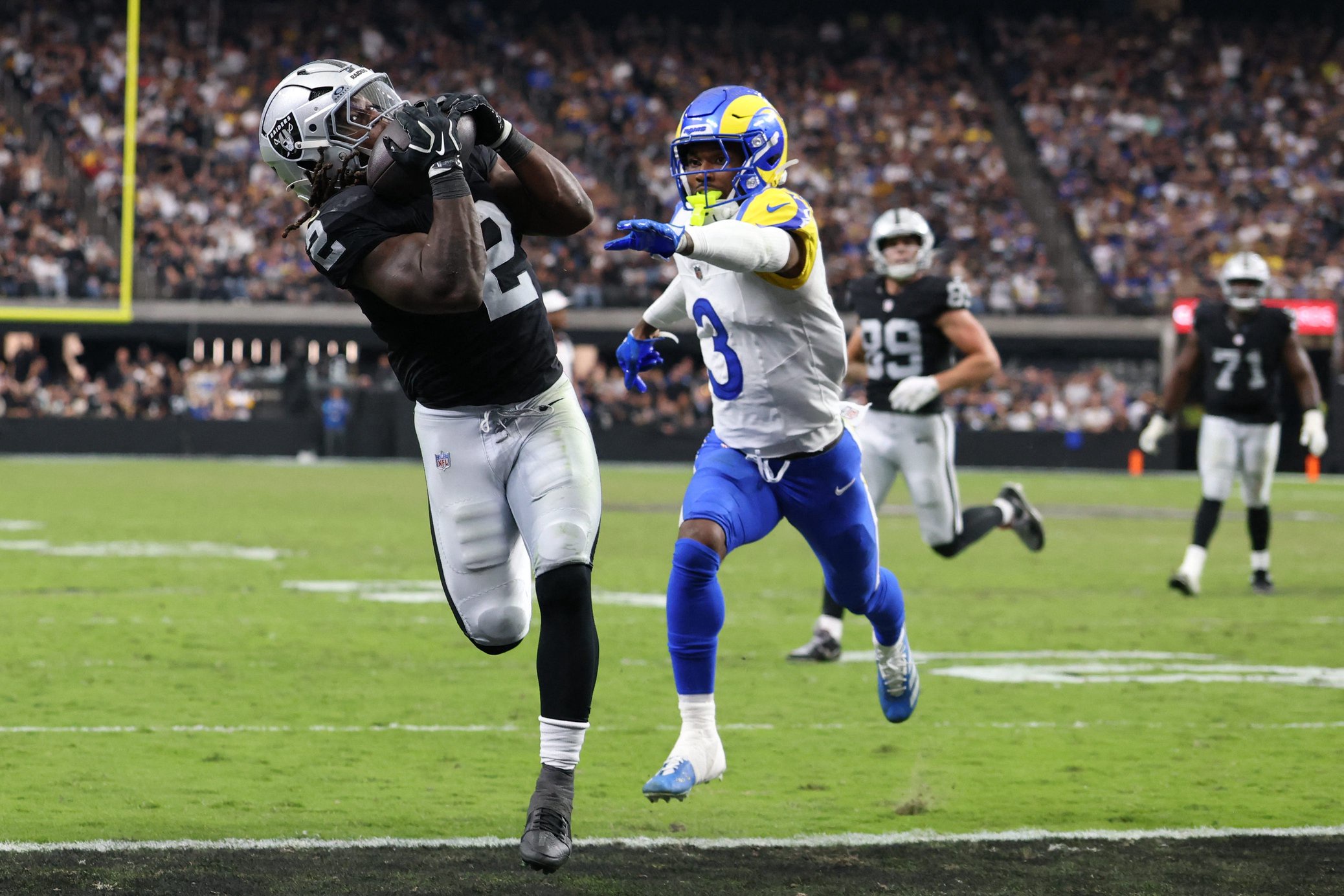 Oct 25, 2026; Paradise, Nevada, USA;  Las Vegas Raiders running back Ashton Jeanty (2) makes a touchdown catch over Los Angeles Rams safety Kam Curl (3)in the second half at Allegiant Stadium.  Mandatory Credit: David Brytus-Imagn Images