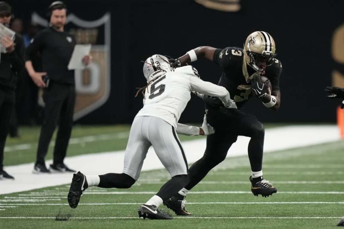Sep 27, 2026; New Orleans, Louisiana, USA; New Orleans Saints running back Travis Etienne Jr. (3) runs with the ball while defended by Las Vegas Raiders cornerback Eric Stokes (5) in the second half at Caesars Superdome. © Matthew Hinton-Imagn Images