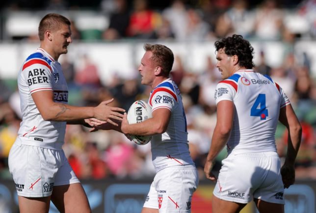 Jez Litten, center, of England is congratulated by teammates after scoring a try during the rugby league World Cup game between England and France in Perth, Australia, Saturday, Oct. 24, 2026. (Richard Wainwright/AAPImage via AP)
