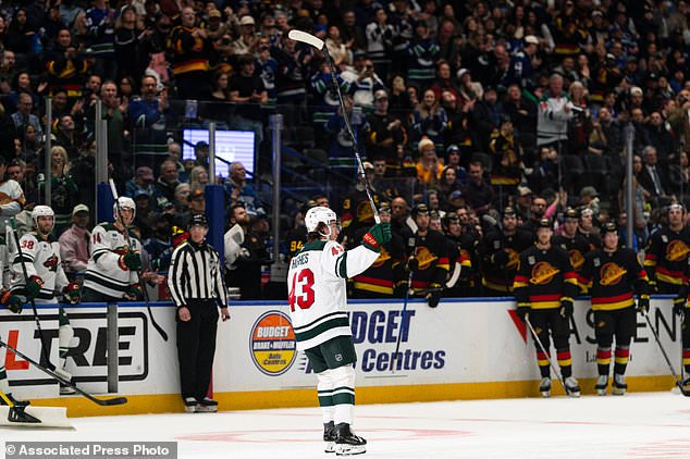 Minnesota Wild's Quinn Hughes (43) waves to the crowd while playing his former team, the Vancouver Canucks, during the first period of an NHL hockey game, in Vancouver, British Columbia, Sunday, Oct. 25, 2026. (Jacob Mallari/The Canadian Press via AP)