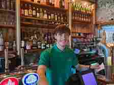 Isaac, behind the bar at Rhubarb Cafe Bar, is looking forward to what Oyé brings to Lark Lane.