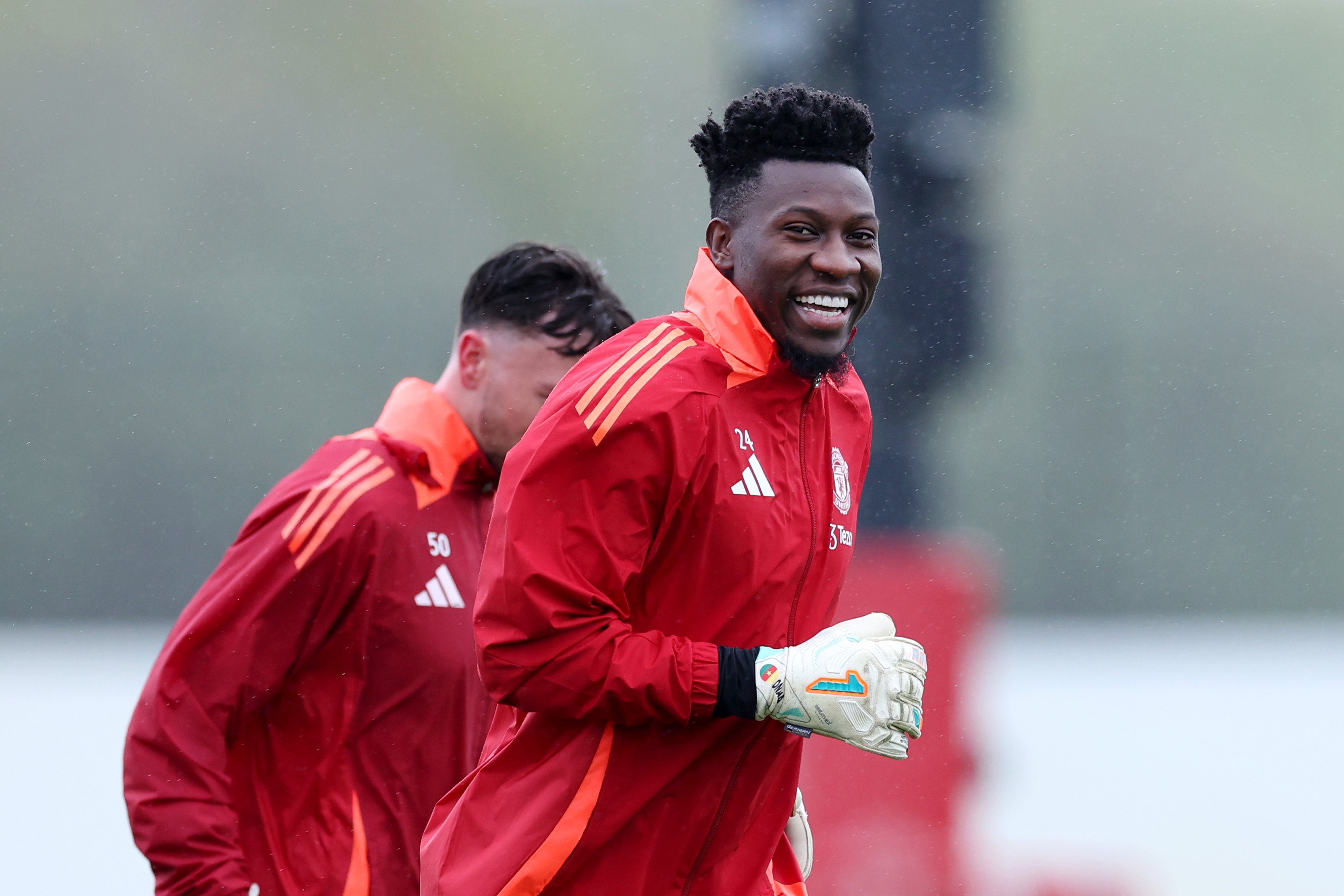 Andre Onana smiles at the camera while training for Man United at Carrington complex.