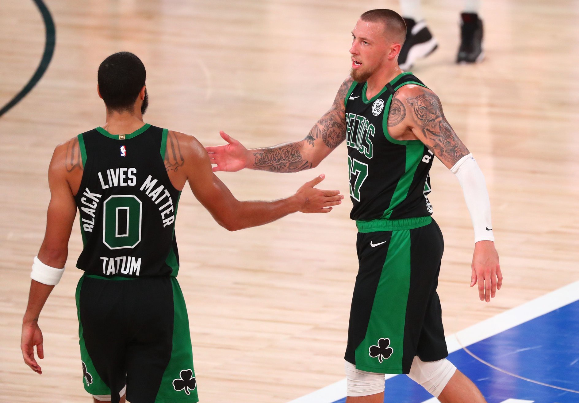 Sep 25, 2020; Lake Buena Vista, Florida, USA; Boston Celtics forward Jayson Tatum (0) celebrates with center Daniel Theis (27) the 121-108 victory against the Miami Heat  following  game five of the Eastern Conference Finals of the 2020 NBA Playoffs at AdventHealth Arena. Mandatory Credit: Kim Klement-USA TODAY Sports